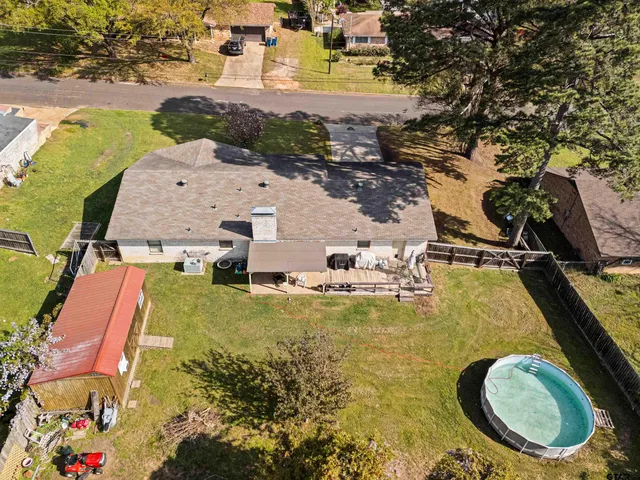 an aerial view of residential houses with outdoor space