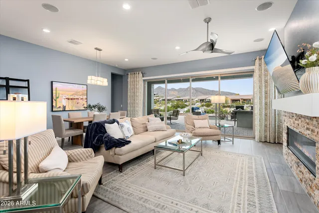 a living room with fireplace furniture and a large window