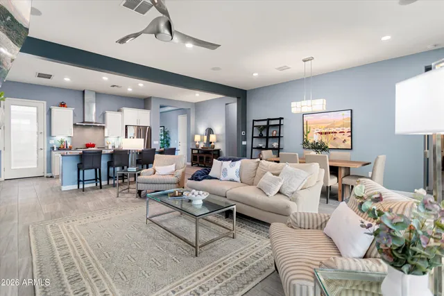 a living room with furniture kitchen view and a table