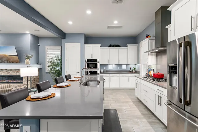 a kitchen with granite countertop cabinets and white appliances