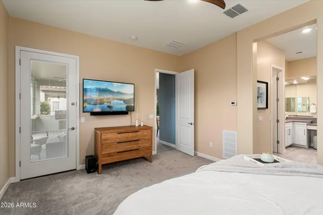 a large white bathroom with a double vanity sink a mirror and shower