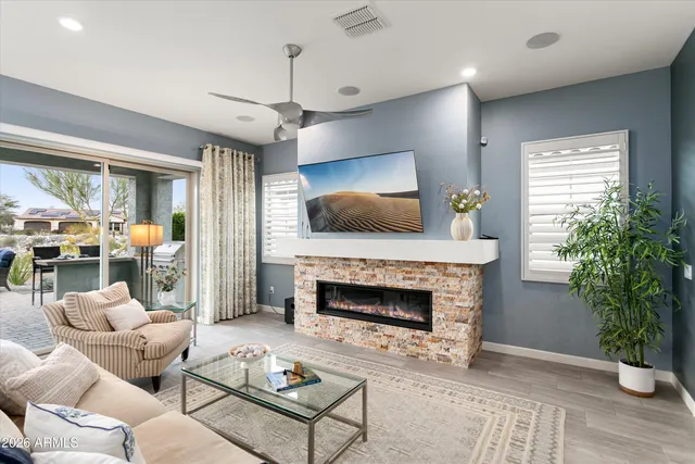 a living room with furniture a flat screen tv and a fireplace