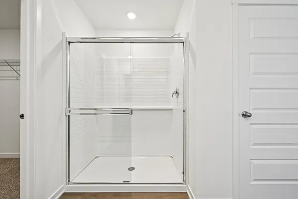 a bathroom with a glass shower door