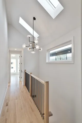 a view of a hallway with wooden floor and staircase