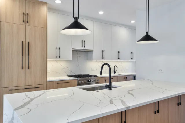 a kitchen with kitchen island a sink stainless steel appliances and cabinets