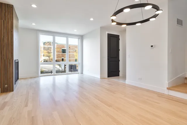 a view of a livingroom with wooden floor and furniture
