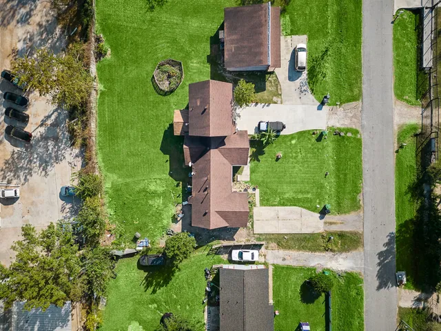 an aerial view of multiple houses with yard