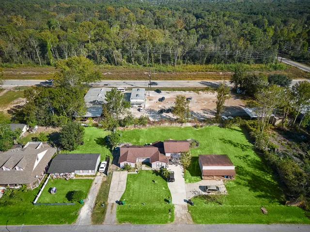 an aerial view of a house with garden space and outdoor seating
