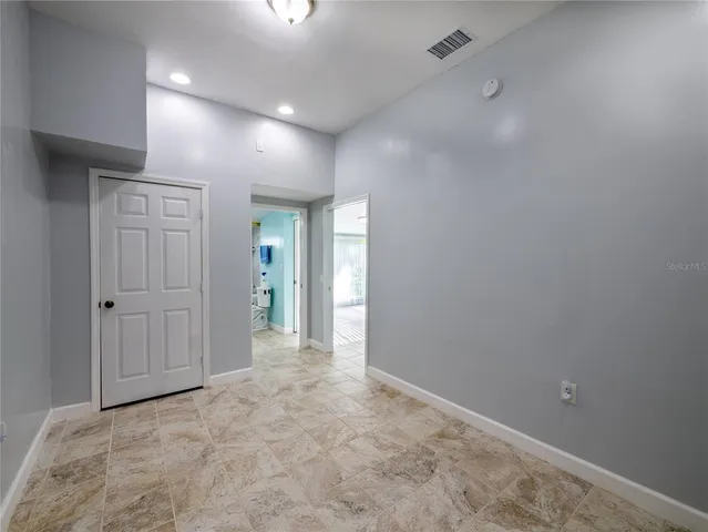 an empty room with closet and wooden floor
