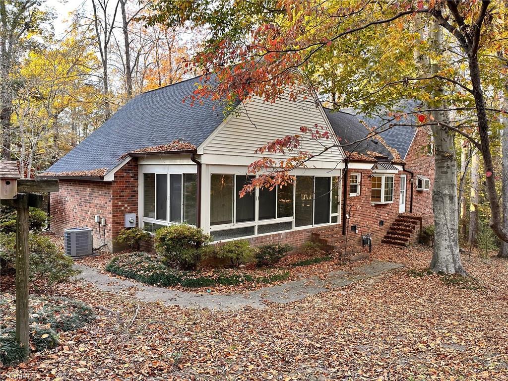 3415 Old Onslow Road Greensboro, NC 27407 - Photo 42 of 45 Rear corner view of home, shows sunroom