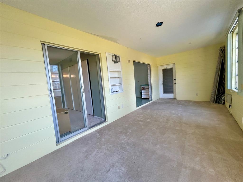 2072 Australia Way West, Unit 32 Clearwater, FL 33763 - Photo 12 of 47 a view of a big room with closet and wooden door