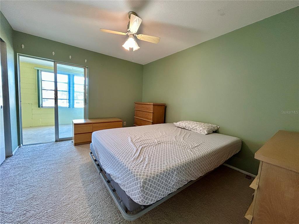 2072 Australia Way West, Unit 32 Clearwater, FL 33763 - Photo 16 of 47 a bedroom with a bed and window
