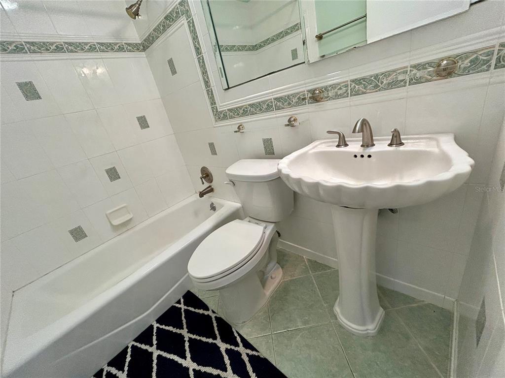 2072 Australia Way West, Unit 32 Clearwater, FL 33763 - Photo 19 of 47 a bathroom with a sink a toilet and shower