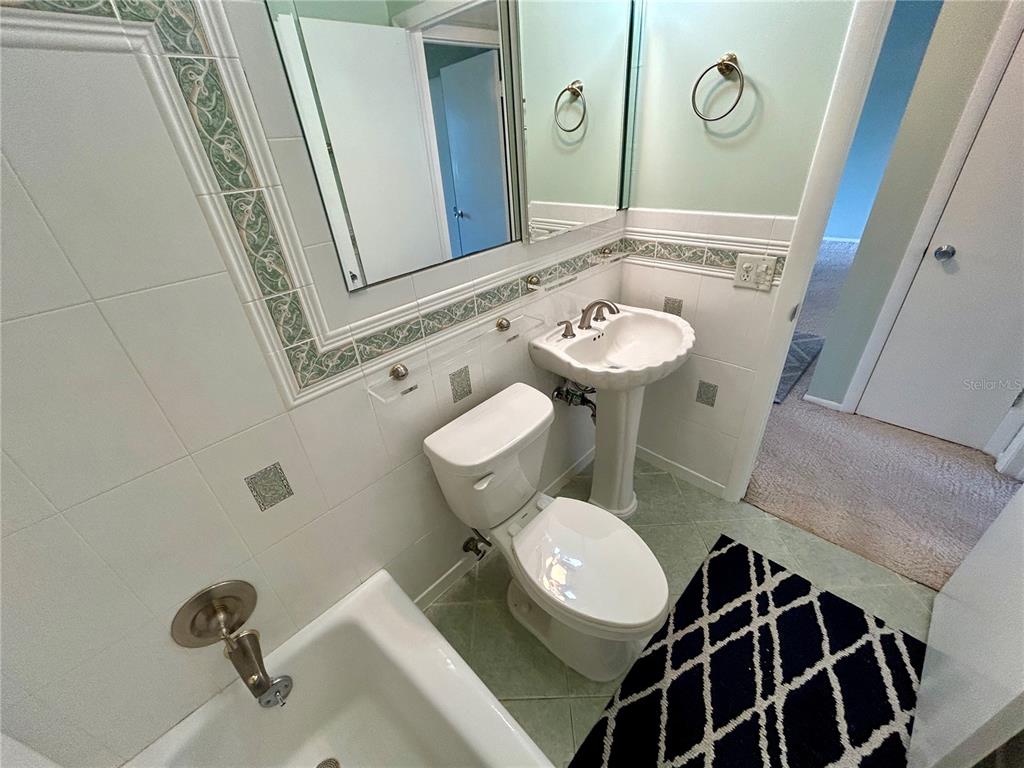 2072 Australia Way West, Unit 32 Clearwater, FL 33763 - Photo 20 of 47 a bathroom with a sink mirror vanity and toilet