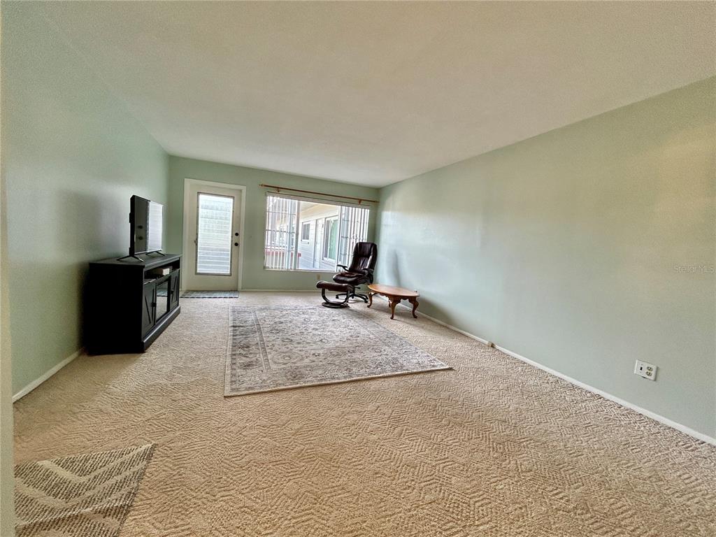 2072 Australia Way West, Unit 32 Clearwater, FL 33763 - Photo 7 of 47 a room with a couch and a flat screen tv