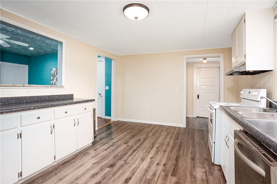 59 Church Street Notasulga, AL 36866 - Photo 28 of 38 This spacious kitchen offers ample room for culinary endeavors and comfortable dining.