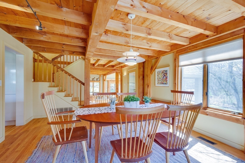 3 South Brook Road Lincoln, MA 01773 - Photo 18 of 40 a view of a dining room with furniture a chandelier and wooden floor