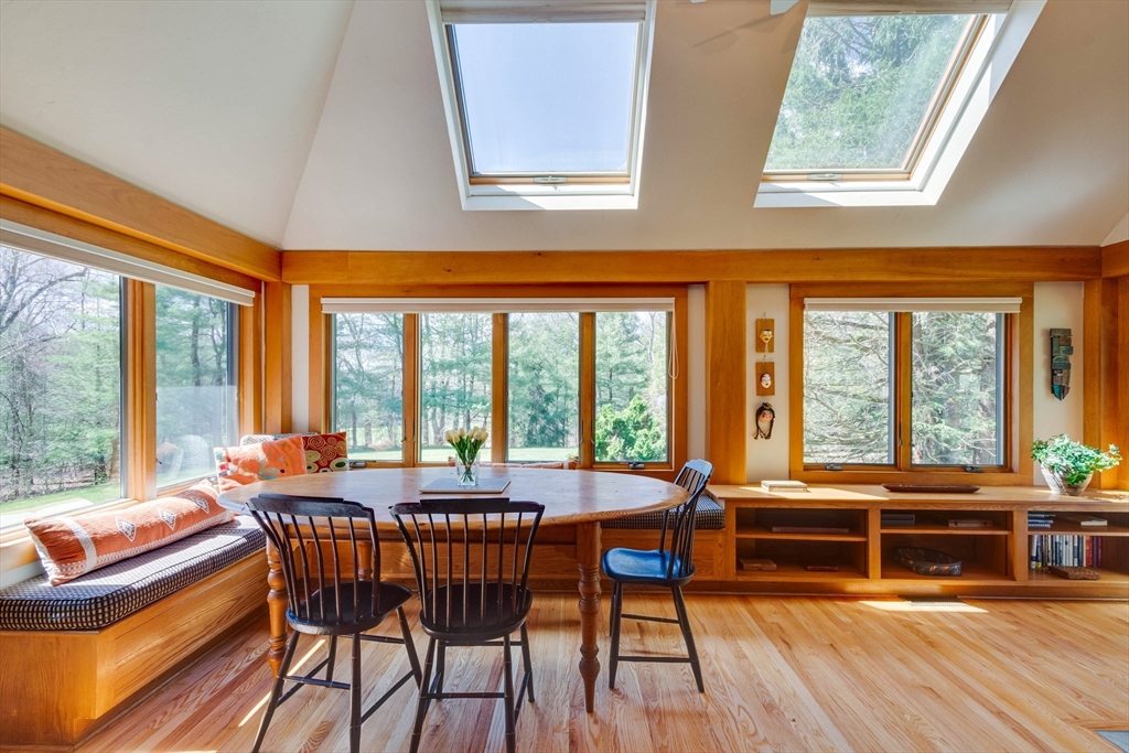 3 South Brook Road Lincoln, MA 01773 - Photo 6 of 40 a dining room with furniture large windows and wooden floor