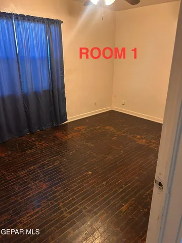 a view of a refrigerator with wooden floor