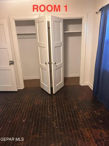 a view of storage and utility room with wooden floor