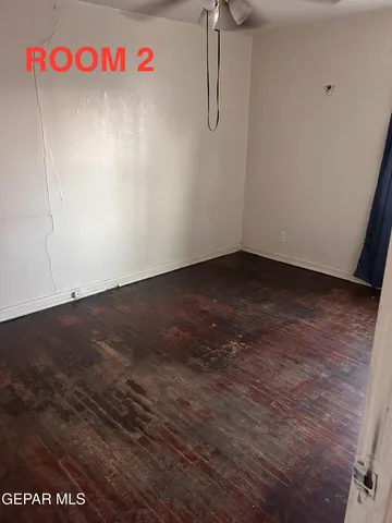 a view of a room with wooden floor