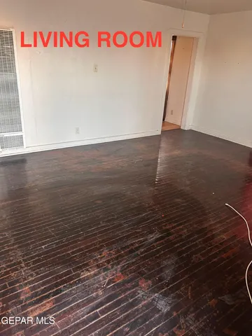 a view of a refrigerator in an empty room