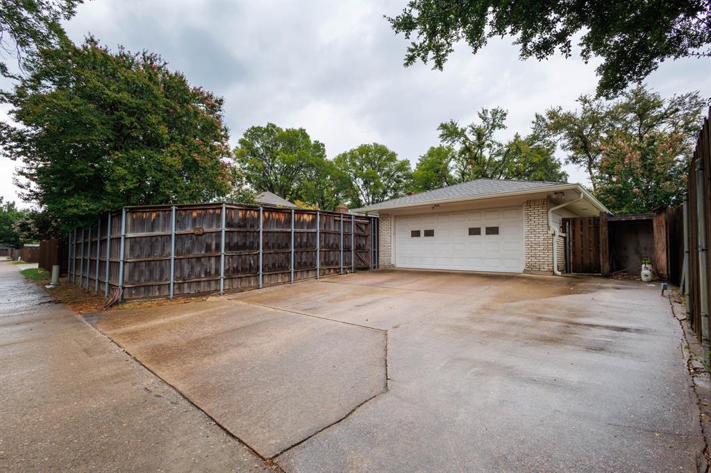 605 East Spring Valley Road Richardson, TX 75081 - Photo 21 of 24 Driveway from alley to garage and RV parking