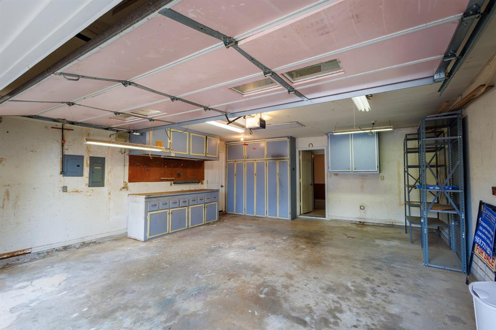 605 East Spring Valley Road Richardson, TX 75081 - Photo 22 of 24 Garage with workbench and storage