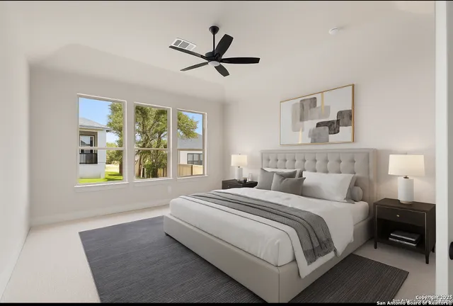 a bedroom with a large bed and a window