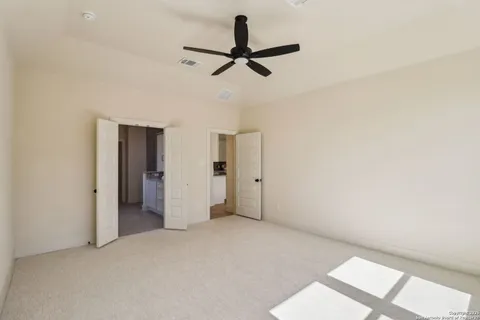 a view of a room with a ceiling fan