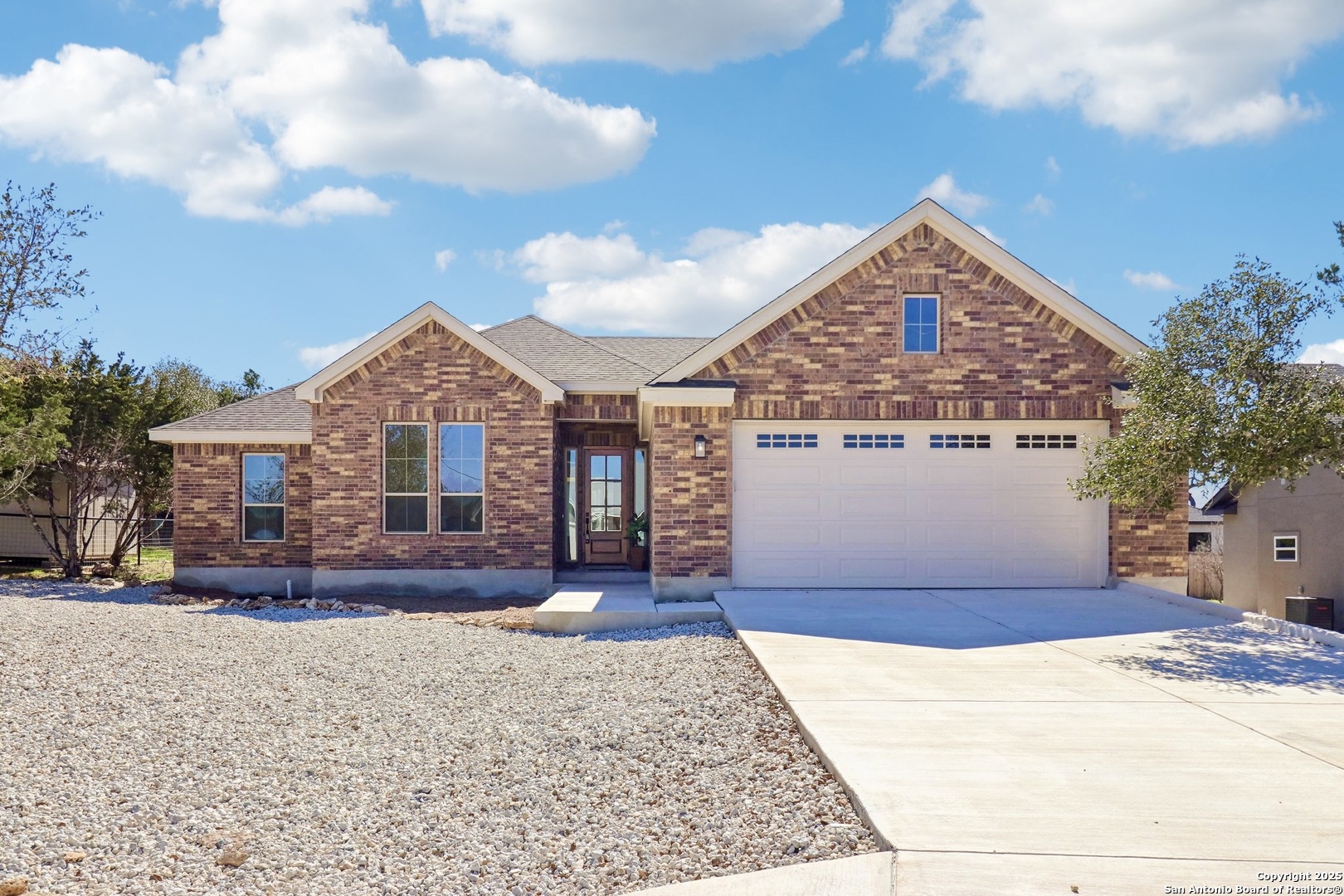104 George Erath Blanco, TX 78606 - Photo 2 of 28 a front view of a house with a yard
