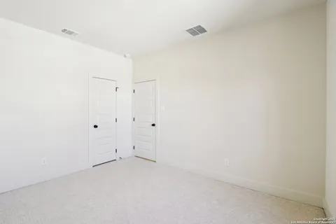 a bathroom with a granite countertop sink a toilet and a mirror