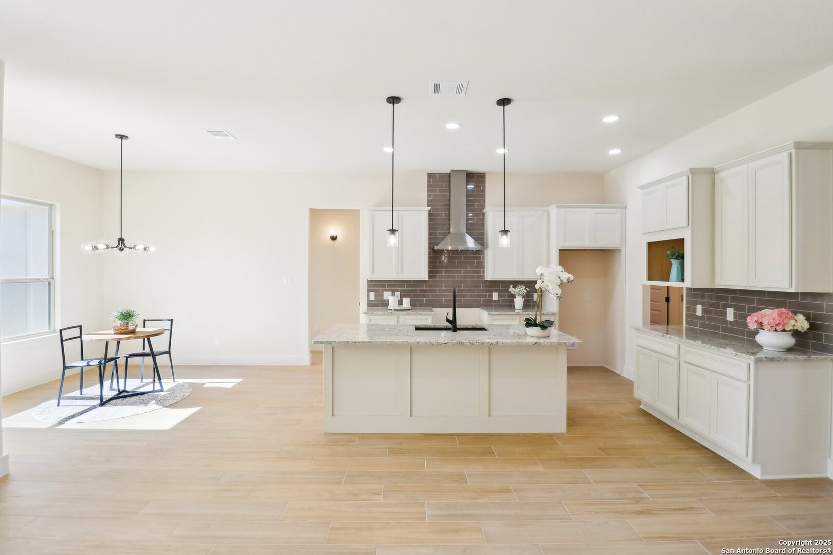 104 George Erath Blanco, TX 78606 - Photo 3 of 28 a kitchen with stainless steel appliances kitchen island sink refrigerator and cabinets