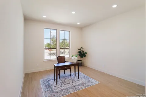 a workspace room with furniture and wooden floor