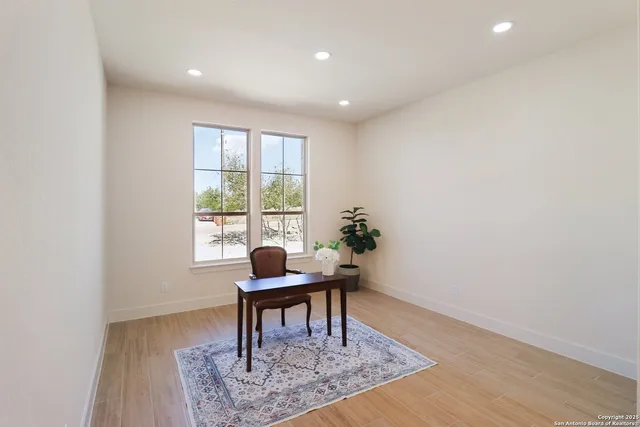 a workspace room with furniture and wooden floor