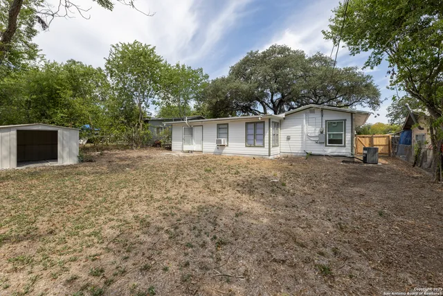 a house with trees in the background