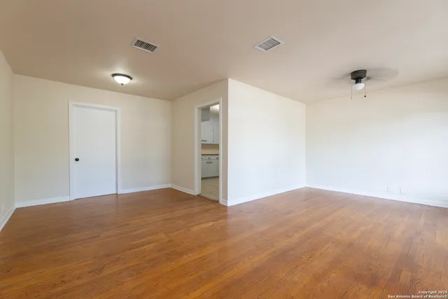 a view of an empty room with a closet