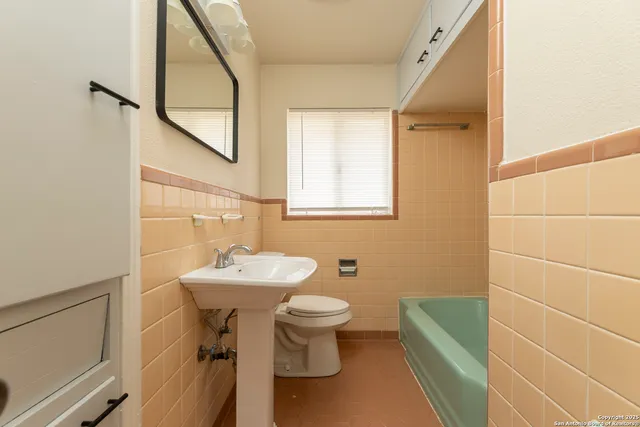 a bathroom with a sink mirror toilet and a mirror