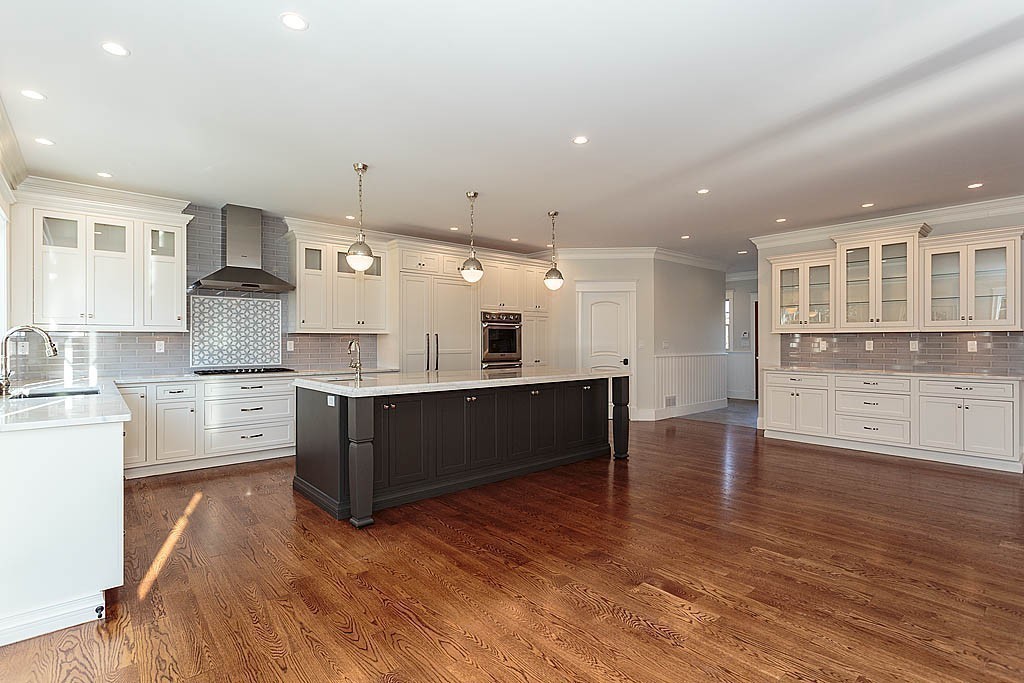 180 Ridge Street Winchester, MA 01890 - Photo 11 of 30 a large kitchen with stainless steel appliances granite countertop a large counter top and a wooden floors