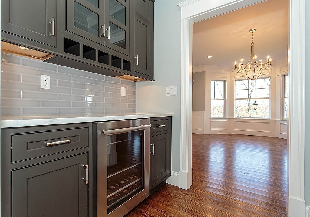 180 Ridge Street Winchester, MA 01890 - Photo 13 of 30 a kitchen with stainless steel appliances granite countertop a stove and a wooden cabinets
