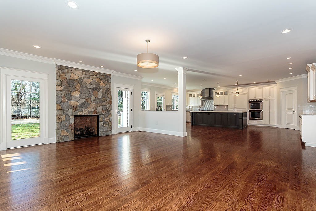 180 Ridge Street Winchester, MA 01890 - Photo 14 of 30 a view of kitchen and hall with wooden floor and a fireplace