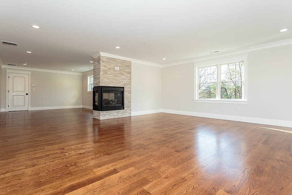 180 Ridge Street Winchester, MA 01890 - Photo 21 of 30 an empty room with wooden floor fireplace and windows