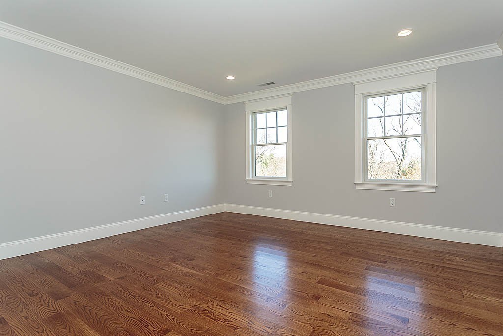 180 Ridge Street Winchester, MA 01890 - Photo 27 of 30 an empty room with wooden floor and windows