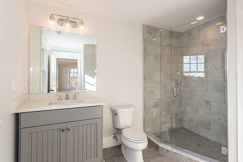 180 Ridge Street Winchester, MA 01890 - Photo 28 of 30 a bathroom with a sink a toilet and shower