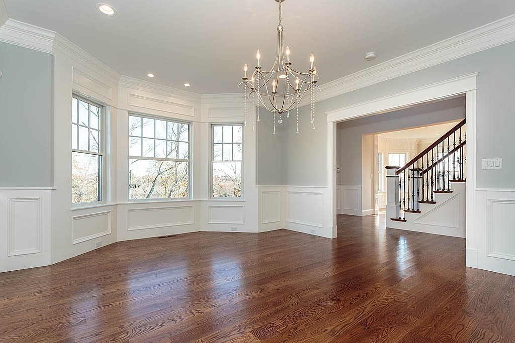 180 Ridge Street Winchester, MA 01890 - Photo 9 of 30 a view of an empty room with wooden floor and a chandelier