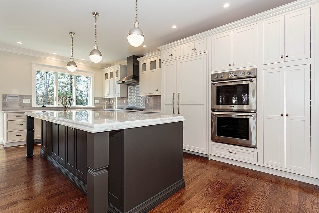 180 Ridge Street Winchester, MA 01890 - Photo 10 of 30 a kitchen with kitchen island granite countertop a stove cabinets and wooden floor