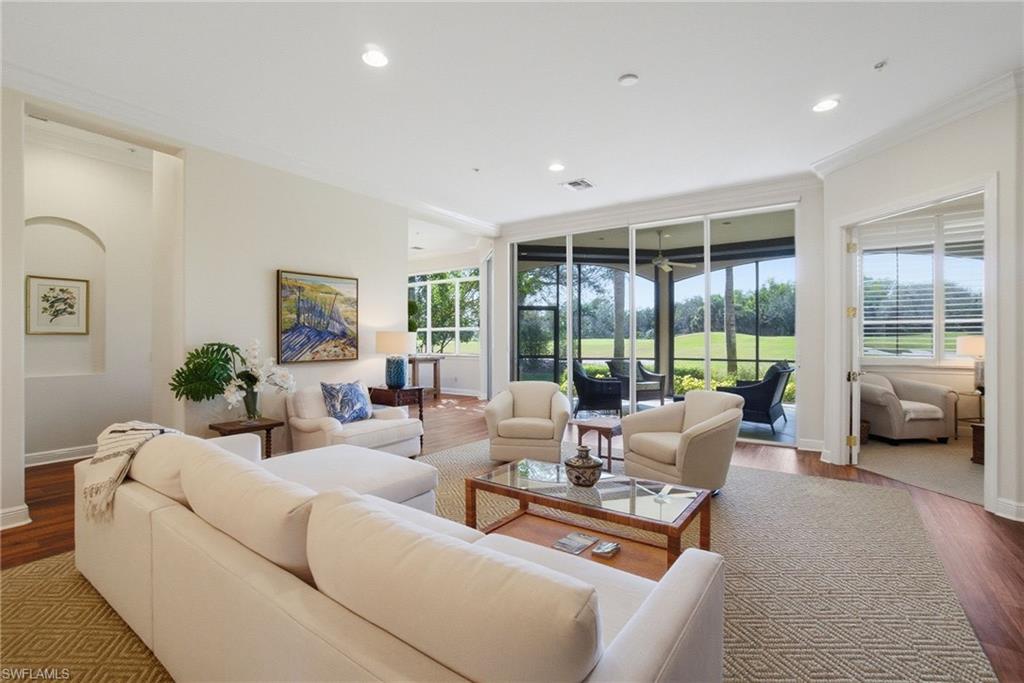 17015 Porta Vecchio Way, Unit 101 Naples, FL 34110 - Photo 3 of 39 a living room with furniture and large windows