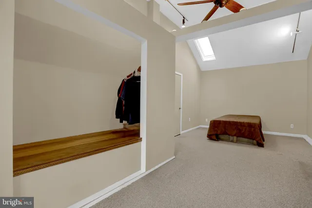 a room with a bed and a ceiling fan