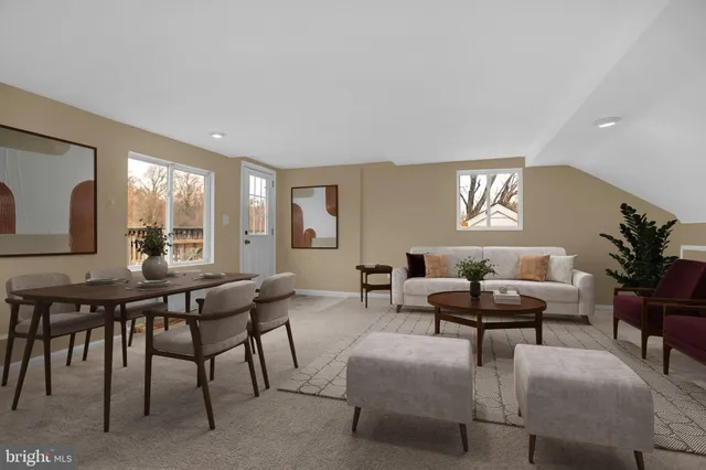 a living room with fireplace furniture and a potted plant