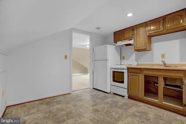 a kitchen with stainless steel appliances a stove oven and white cabinets